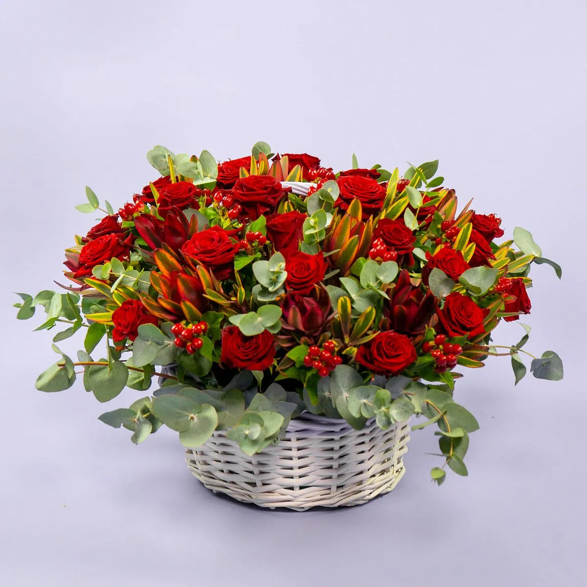 31 розы и эвкалипта в корзине